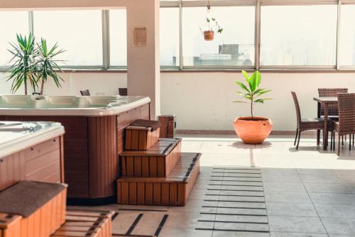 a bathroom with a sink and a potted plant at Hotel Central Plaza Medellin in Medellín