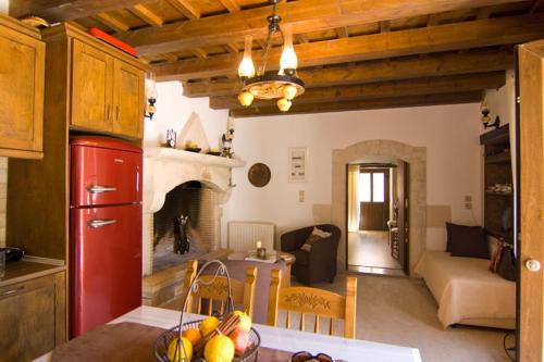 a kitchen and a living room with a fireplace at Eleni's Stately Home, picturesque location, By ThinkVilla in Garazo
