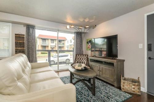 a living room with a couch and a flat screen tv at HOLLY FIRST FLOOR 2 King Beds in Kansas City