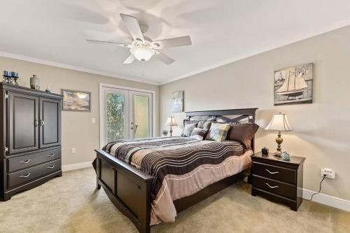 a bedroom with a bed and a ceiling fan at Seaside Treasure in Biloxi