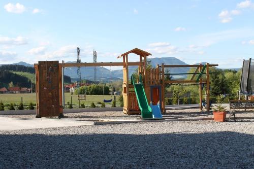a playground with a slide and a swing at Liptovsky Zrub in Gôtovany