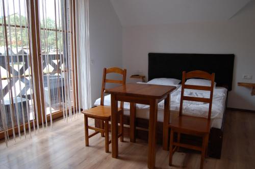 a room with a table and chairs and a bed at Cisna Chata - Bieszczady in Cisna
