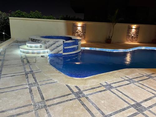 a swimming pool with two stools in front at Awesome Villa on a hill Families only in Cairo