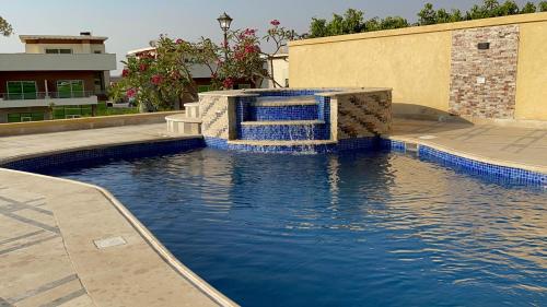 a pool with a water fountain in a building at Awesome Villa on a hill Families only in Cairo