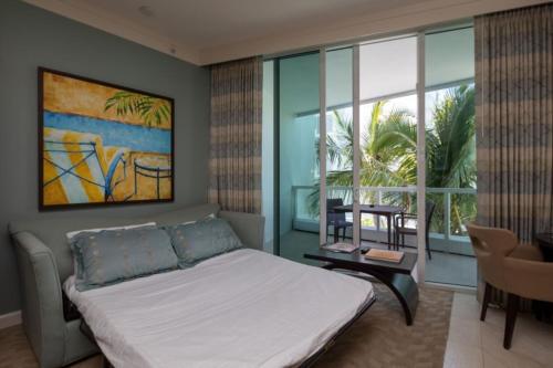 a bedroom with a bed and a large window at One-Bedroom Apartment in Miami Beach
