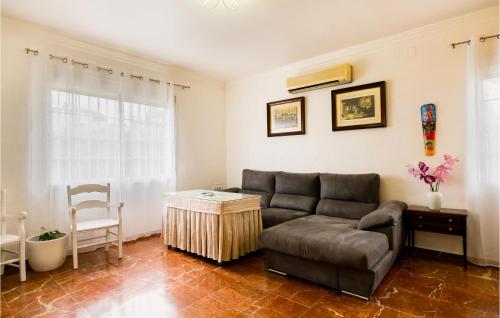 a living room with a couch and a table at Lovely Home In Valencina De La Concep in Valencina de la Concepción