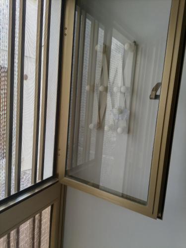 a sliding glass door with a window in a bathroom at La Cameretta di Casa Hemingway in Barisciano
