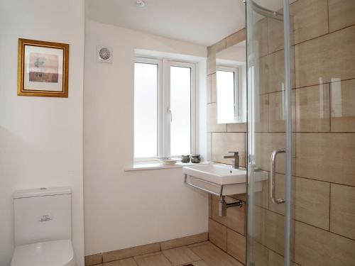 a bathroom with a sink and a glass shower at North Laine Cottage in Brighton & Hove