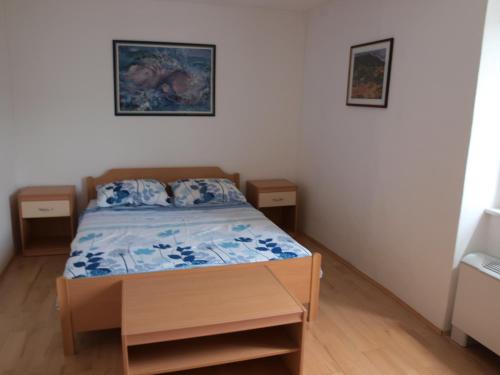 a small bedroom with a bed and two night stands at House Vodice in Vodice