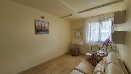 a living room with a couch and a window at Magnolia Luxury Apartment by AltamarHomes in Adeje