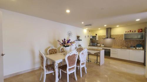 a kitchen and dining room with a table and chairs at Magnolia Luxury Apartment by AltamarHomes in Adeje