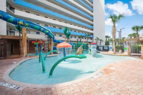a pool with a water slide in a building at Oceanfront 3BR/2BA, Ocean Reef, Waterpark in Myrtle Beach
