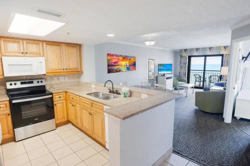 a kitchen with a sink and a stove top oven at Oceanfront 3BR/2BA, Ocean Reef, Waterpark in Myrtle Beach