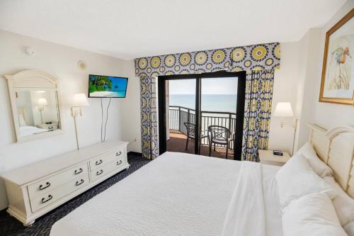 a bedroom with a bed and a view of the ocean at Oceanfront 3BR/2BA, Ocean Reef, Waterpark in Myrtle Beach