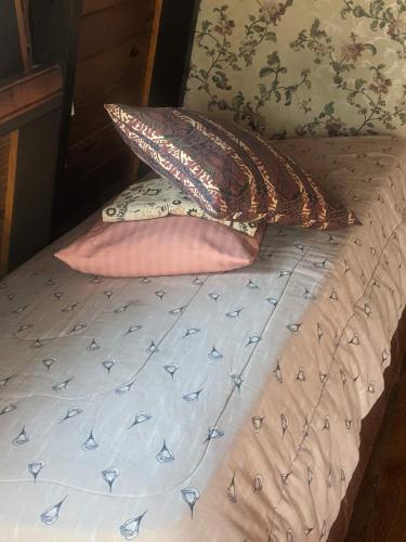 a bed with two pillows on top of it at Habitación Boutique in Villa Alsina