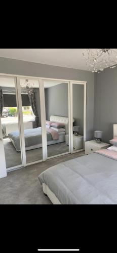 a bedroom with two beds and a large mirror at Perfect 4 bedroom 2 bathroom Home in Edinburgh