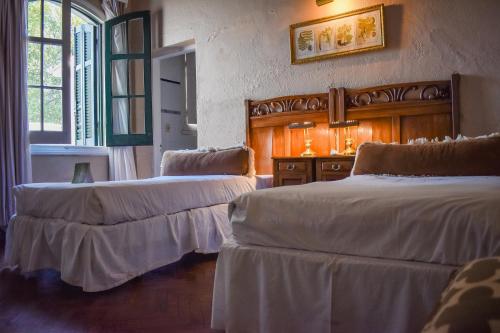 a room with two beds and a window at Estancia Turística San Pedro de Timote in Reboledo