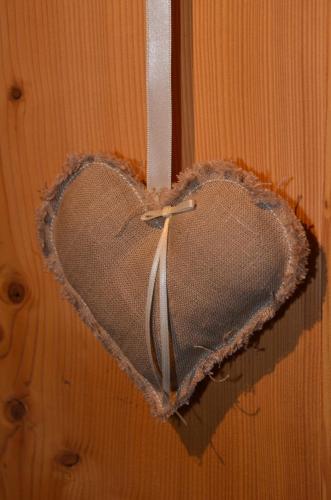 a heart hanging on a door with a string at Hotel Belmont in Engelberg