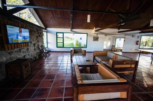 a living room with couches and a flat screen tv at Estancia Turística San Pedro de Timote in Reboledo