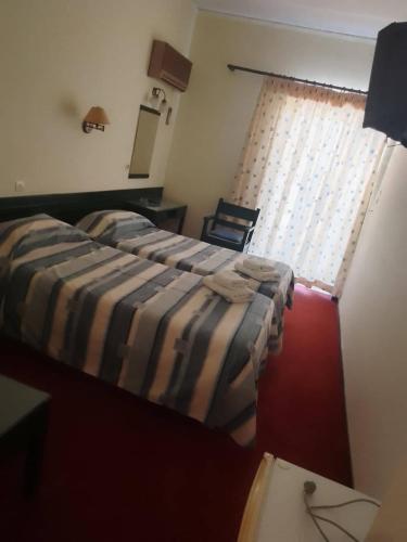 a bedroom with a bed and a window at Ermionida in Kranidi