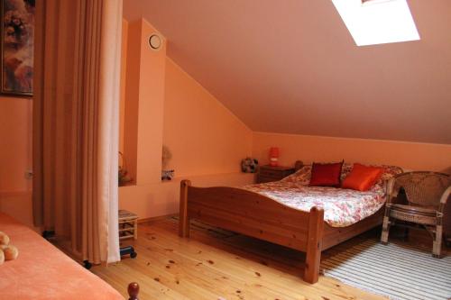 a bedroom with a bed with red pillows on it at Arabela in Rīga