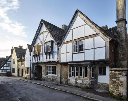 an old house on a street in the medieval town at Sign of the Angel in Lacock