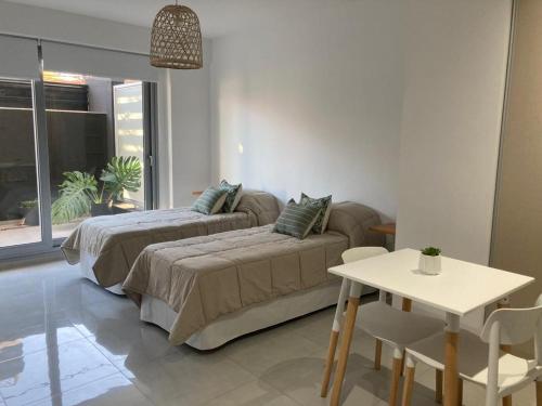 a living room with a bed and a table at PELLERANO APARTMENT in Adrogué