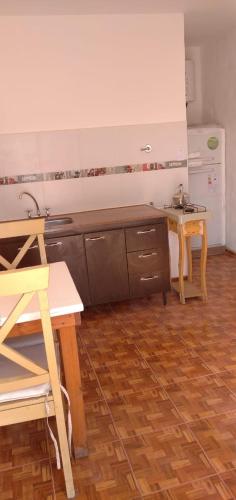 a kitchen with a sink and a counter top at Sierras Altas Alojamientos in Villa Carlos Paz