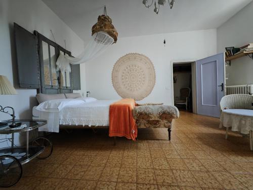 a bedroom with a bed and a couch and a chair at B&B LaMaGia di Corte Moronati in Sirmione