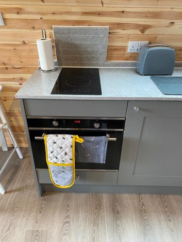 a kitchen with a stove and a counter top at Mowbray Cottages & Glamping in South Kilvington