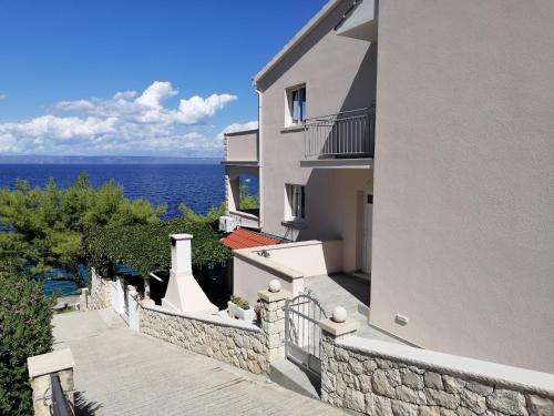 a large white building with a view of the ocean at Apartment D&D in Prigradica