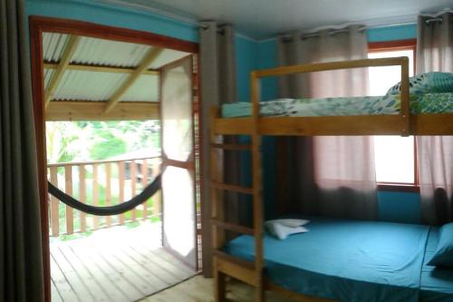 two bunk beds in a room with a balcony at Drake Lapas in Drake