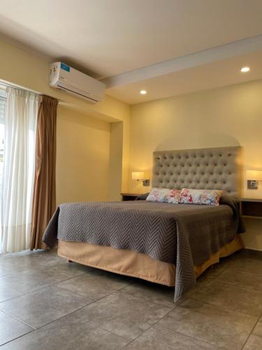 ein Schlafzimmer mit einem großen Bett in einem Zimmer in der Unterkunft Departamentos Sol y Arena in San Clemente del Tuyú