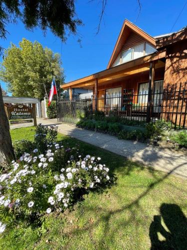 a house with flowers in front of it at Hostal Katemu in Villarrica