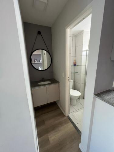 a bathroom with a sink and a mirror at Flat Boa Viagem luxo in Recife