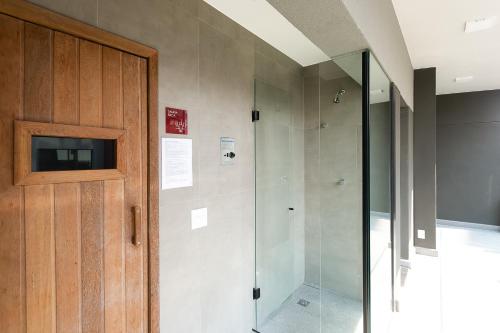 a bathroom with a shower and a glass door at VN Capote Valente 712 no coração de São Paulo in Sao Paulo