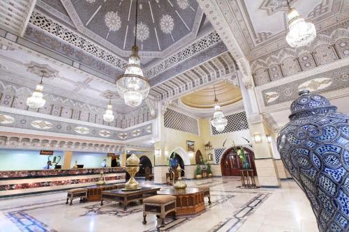 a lobby of a building with ornate ceilings at Pickalbatros Alf Leila Wa Leila Resort - Neverland Hurghada in Hurghada