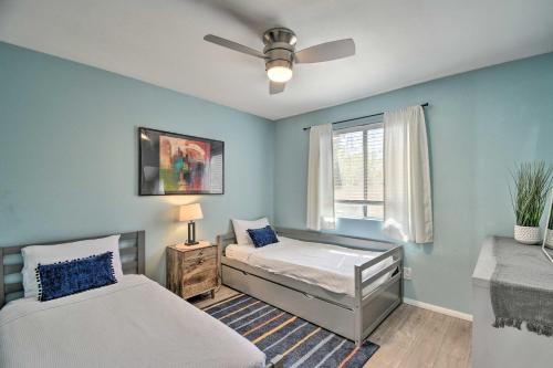 a bedroom with two beds and a ceiling fan at Beautiful Mesa Escape with Yard and Private Pool! in Mesa