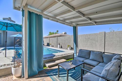 a patio with a couch and a table and a pool at 1 Mi to Dobson Ranch Modern Escape with Gazebo! in Mesa