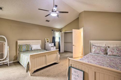 a bedroom with two beds and a ceiling fan at Family Retreat about 1 Mi to Hill Country Mile! in Boerne