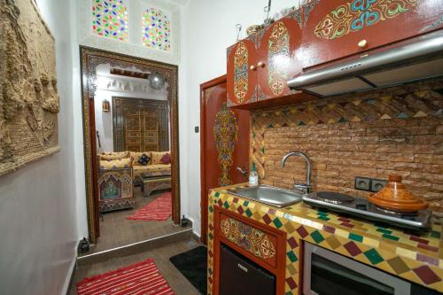 a kitchen with a sink and a counter top at Dar Dahab in Fez