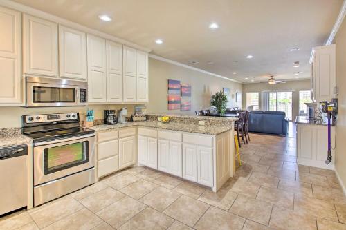 a large kitchen with white cabinets and a counter top at Balcony and Boat Slip Lakefront Unit in Hot Springs in Hot Springs