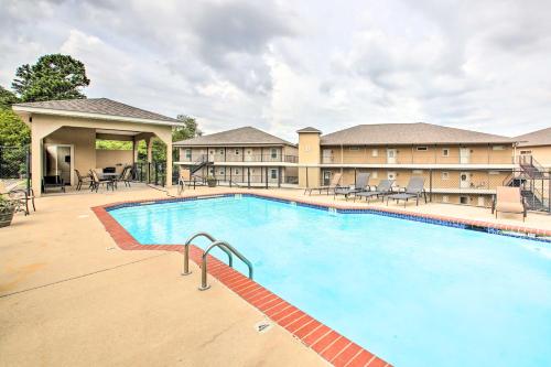 a pool at a hotel with tables and chairs at Balcony and Boat Slip Lakefront Unit in Hot Springs in Hot Springs