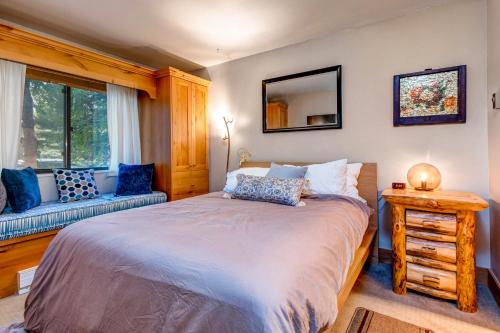 a bedroom with a bed and a couch and a mirror at Whispering Red Pine Paradise in Park City