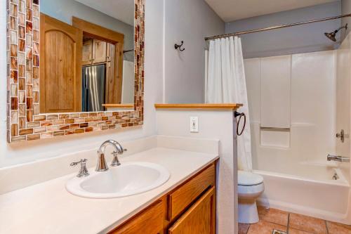 a bathroom with a sink and a toilet at Whispering Red Pine Paradise in Park City