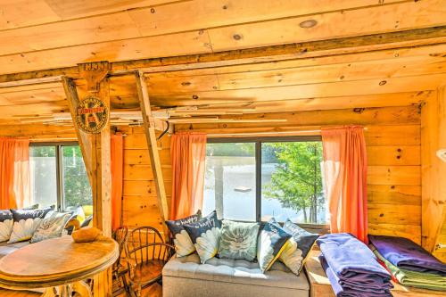 a living room with a couch and a table at Dreamy Bucksport Hideaway on Freshwater Pond! in Bucksport