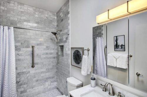a bathroom with a shower and a sink and a toilet at Stylish Tucson Home with Patio and Private Pool! in Tucson