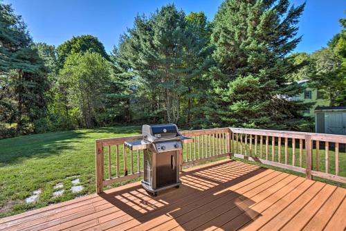 a grill on the deck of a house at Charming Saco Home with Deck, 5 Mi to Beach! in Saco
