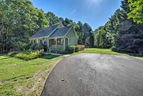 a house with a driveway in front of a yard at Charming Saco Home with Deck, 5 Mi to Beach! in Saco