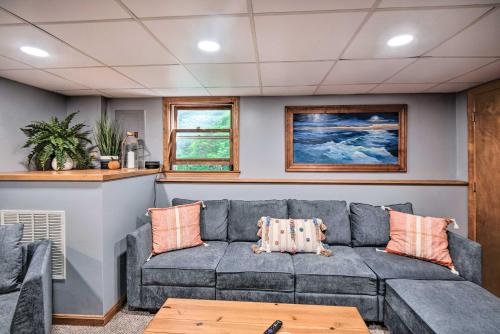 a living room with a couch and a table at Charming Saco Home with Deck, 5 Mi to Beach! in Saco